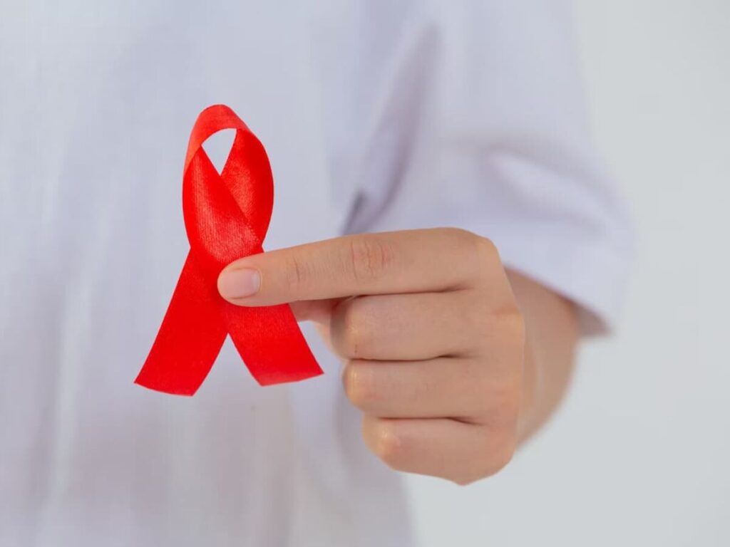 Imagem de um laço vermelho, símbolo de conscientização sobre o HIV, representando as campanhas de prevenção.